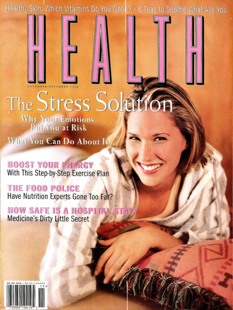 The November/December 1996 cover of Health magazine featuring a model in a Carushka grey and white striped fleece zip-up hoodie. This late-90s look highlights the brand's transition into cozy, lifestyle-driven activewear and luxury fleece fabrics.
