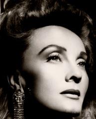Dramatic black and white close-up portrait of Carushka Jarecka by legendary Hollywood photographer George Hurrell, capturing a sophisticated, cinematic profile that highlights her role as a fashion icon and the 'Architect of Movement.'