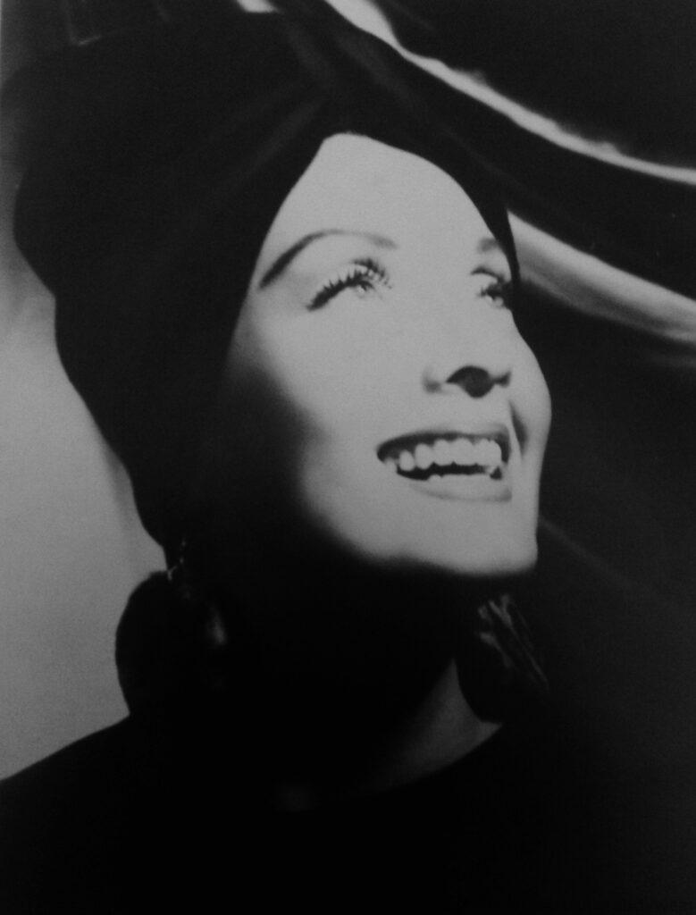 A dramatic black and white portrait of Carushka Bodywear designer, Carushka Jarecka, by George Hurrell, featuring his signature high-contrast Hollywood lighting reminiscent of Hollywood Movie Stars in the Golden Age of Hollywood.